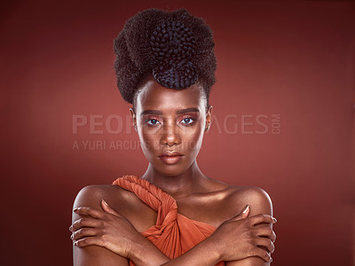 Buy stock photo Cropped portrait of an attractive young woman posing in studio against a red background