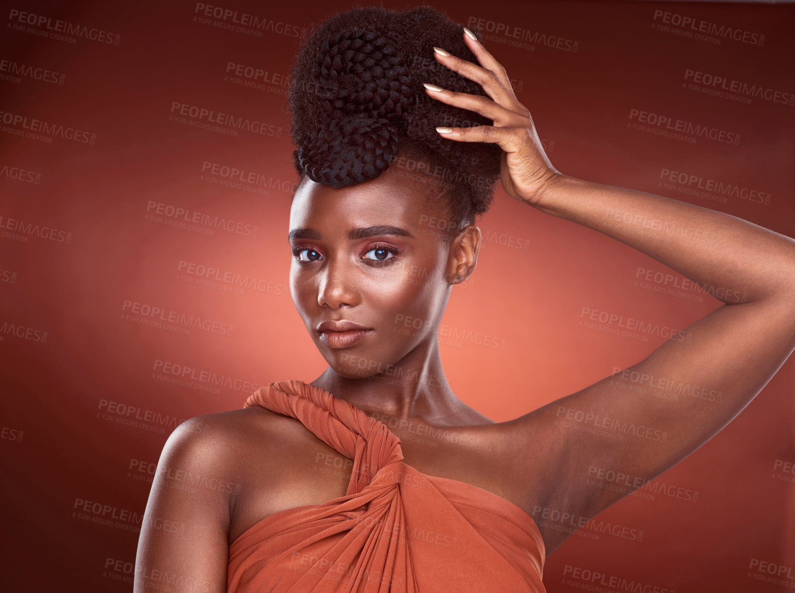 Buy stock photo Cropped portrait of an attractive young woman posing in studio against a red background