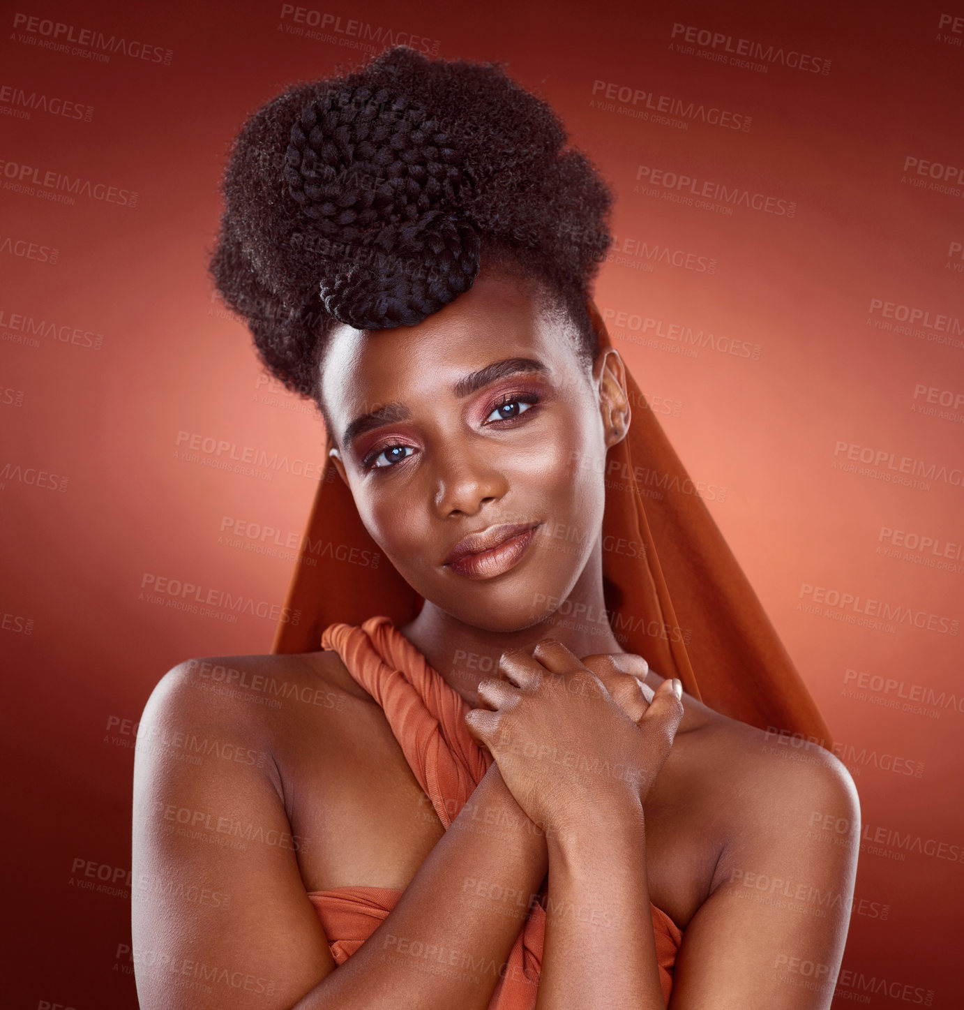 Buy stock photo Cropped portrait of an attractive young woman posing in studio against a red background