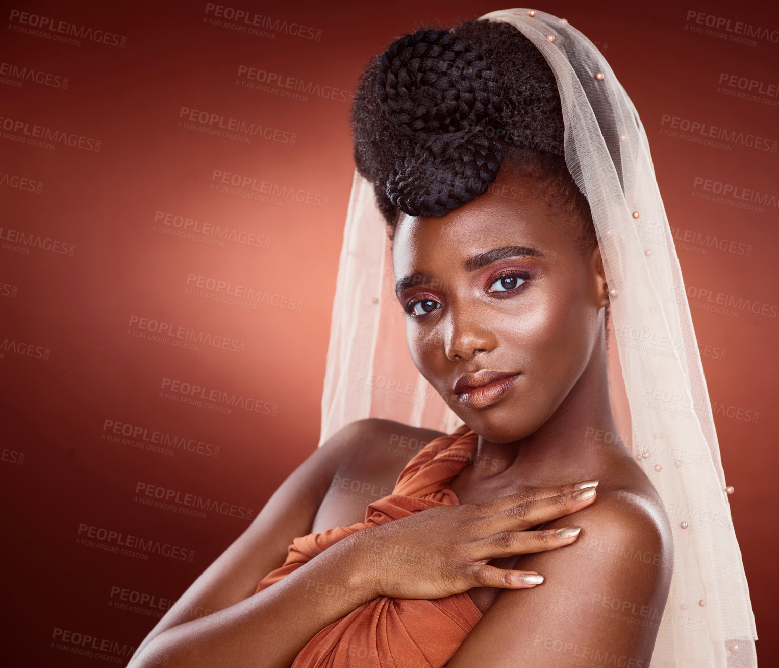 Buy stock photo Cropped portrait of an attractive young woman posing in studio against a red background