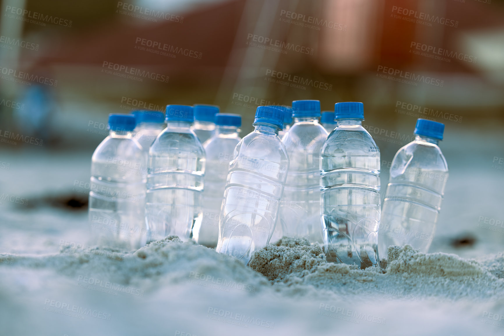 Buy stock photo Shot of bottles laying on the beach