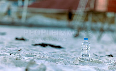 Buy stock photo Shot of a bottle laying on the beach