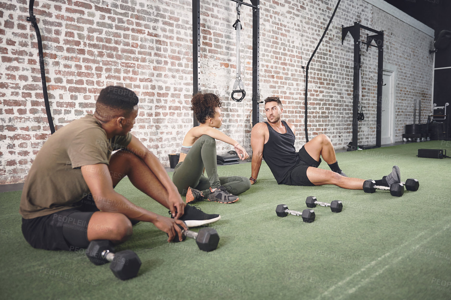 Buy stock photo Shot of a fitness group resting after working out with dumbbells