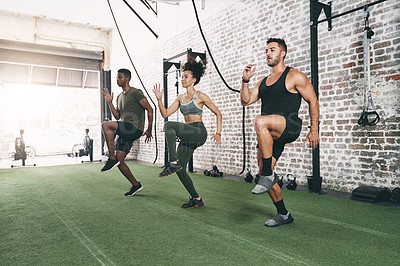 Buy stock photo Shot of a fitness group doing high knees while working out at the gym