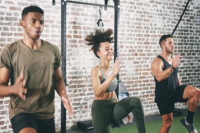 Buy stock photo Shot of a fitness group doing high knees while working out at the gym