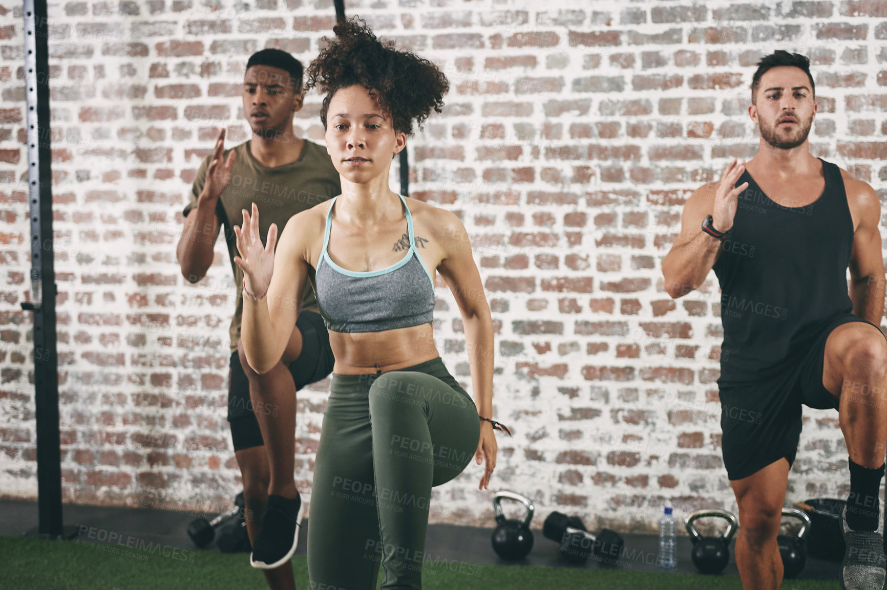 Buy stock photo Shot of a fitness group doing high knees while working out at the gym