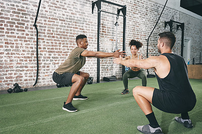 Buy stock photo Shot of a fitness group doing squats while working out at the gym