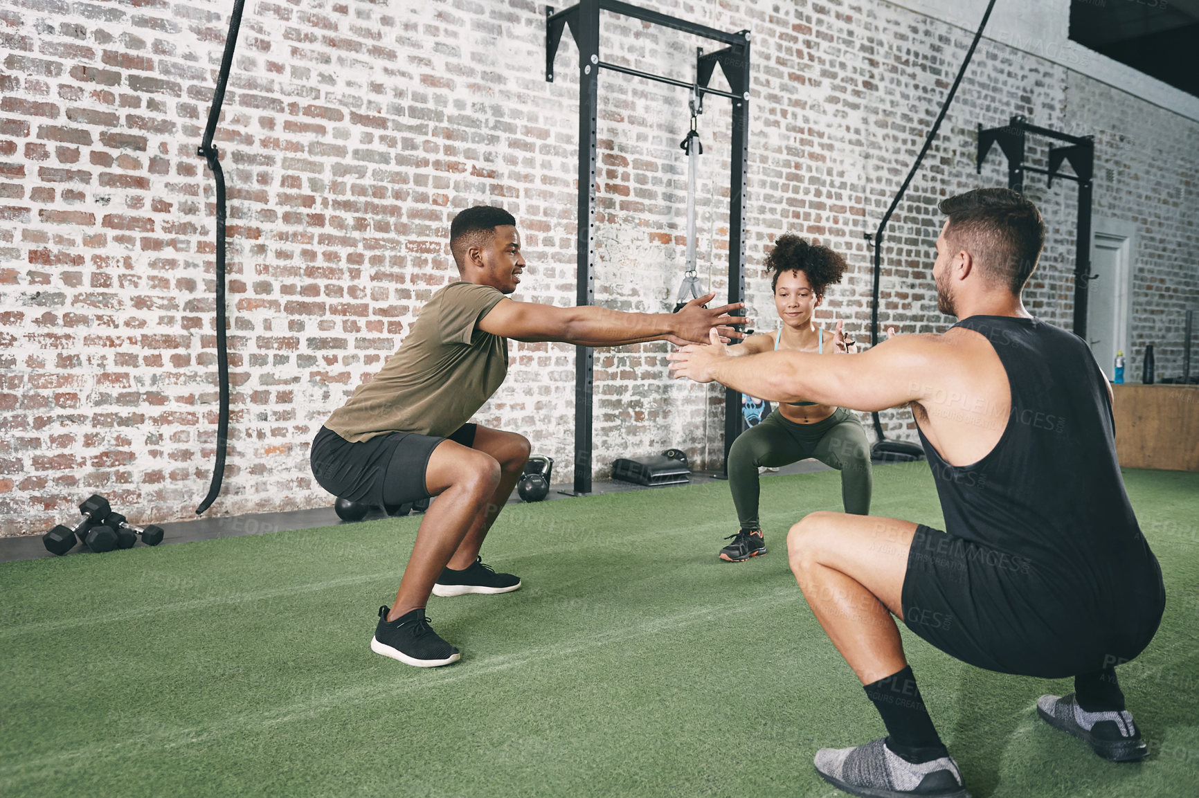 Buy stock photo Shot of a fitness group doing squats while working out at the gym