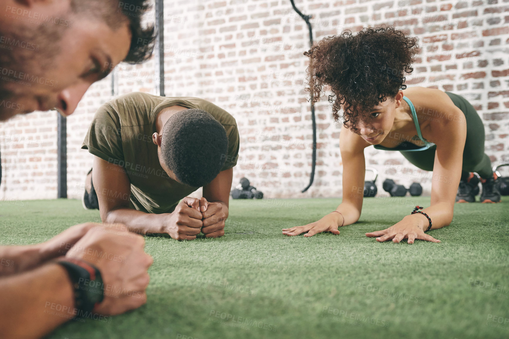 Buy stock photo Shot of a fitness group planking while working out at the gym