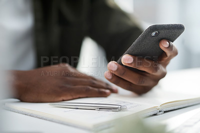 Buy stock photo Cropped shot of a young man using his phone at work