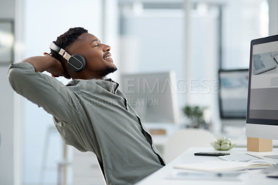 Buy stock photo Shot of a young man on a call at work in a office