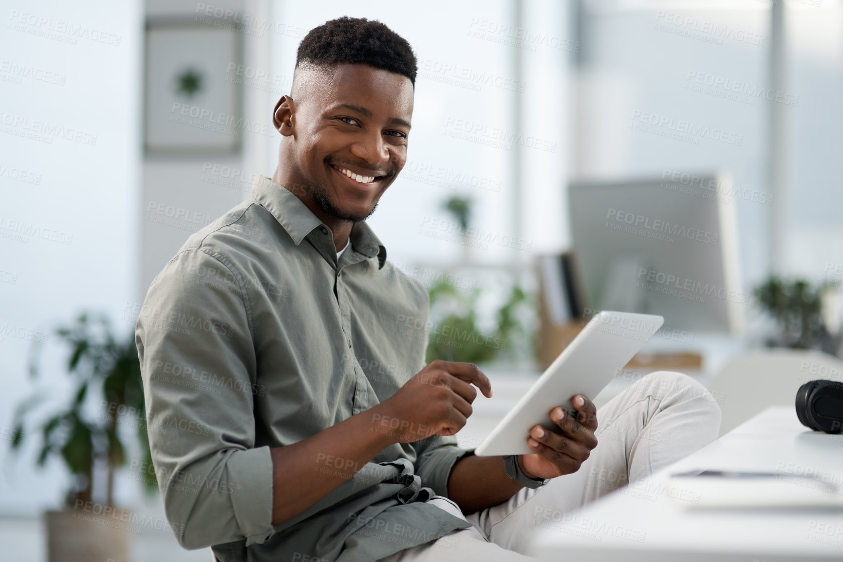 Buy stock photo Shot of a young businessman working on a computer in an office