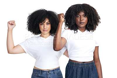 Buy stock photo Studio shot of two young women raising their fists in solidarity against a white background