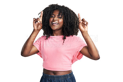 Buy stock photo Studio shot of an attractive young woman pointing upwards against a white background