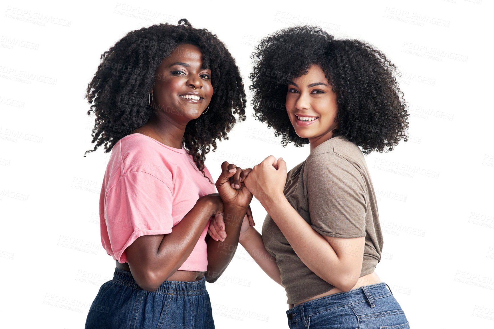 Buy stock photo Studio shot of two young women linking their fingers against a white background