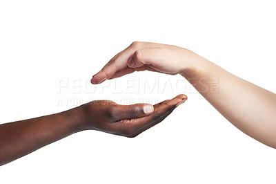 Buy stock photo Cropped studio shot of two women reaching their hands out to each other against a white background