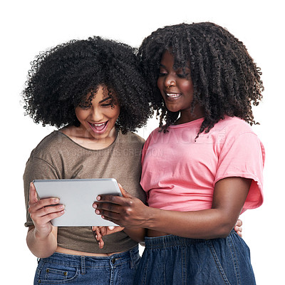 Buy stock photo Studio shot of two young women using a digital tablet against a white background