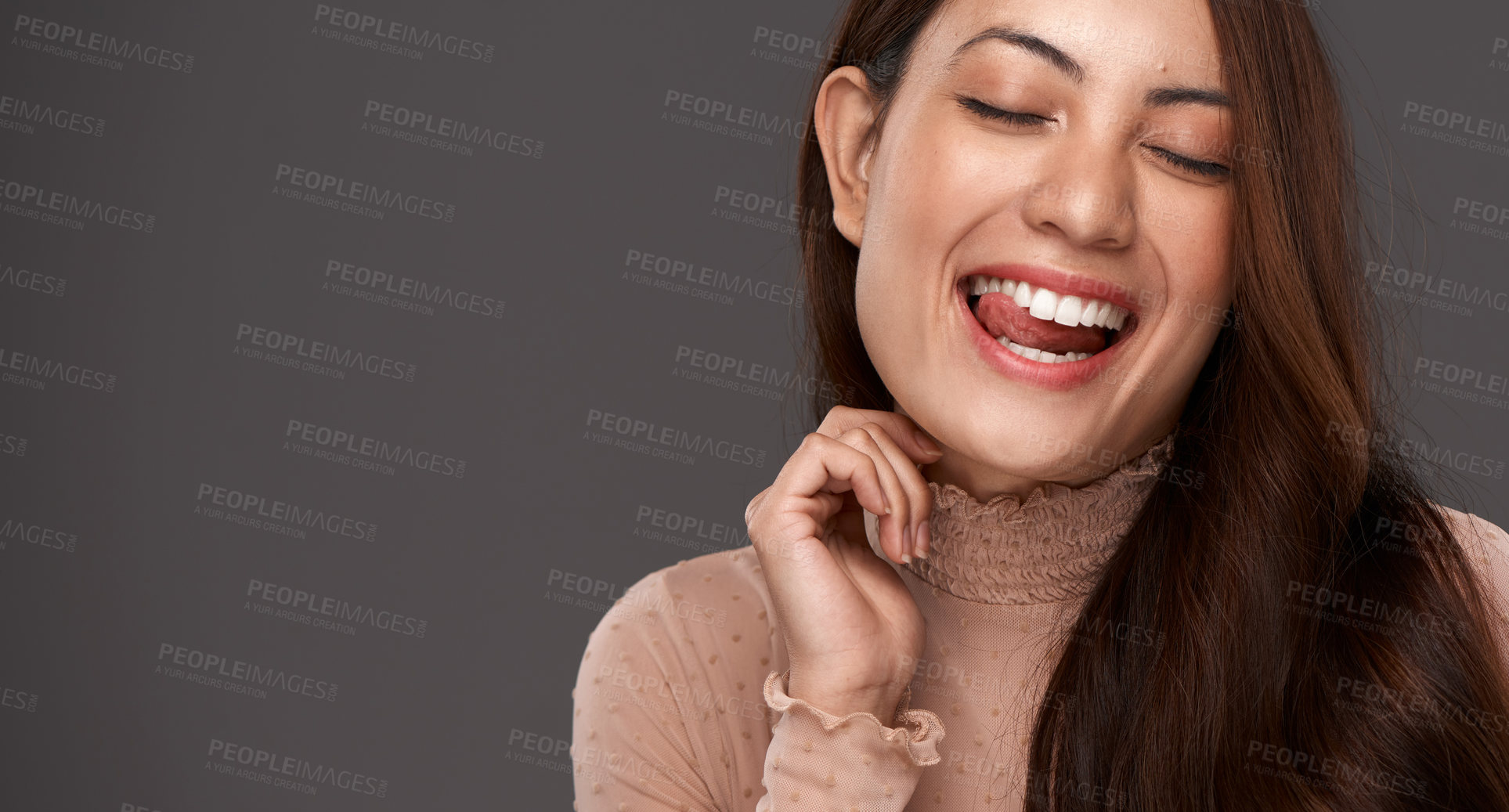 Buy stock photo Cropped shot of an attractive young woman making a face in studio against a grey background