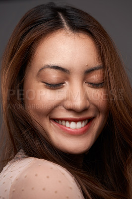 Buy stock photo Cropped shot of an attractive young woman posing in studio against a grey background