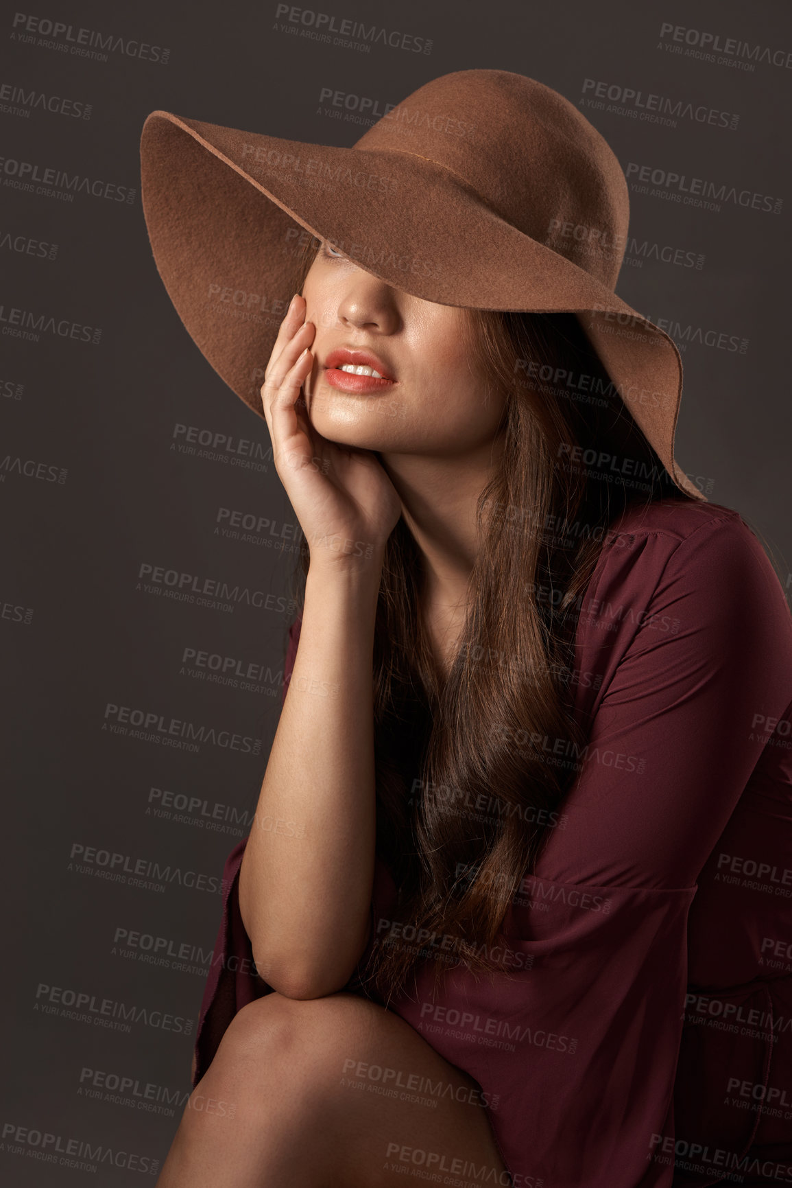 Buy stock photo Cropped shot of an attractive young woman posing in studio against a grey background