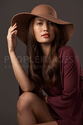 Buy stock photo Cropped portrait of an attractive young woman posing in studio against a grey background