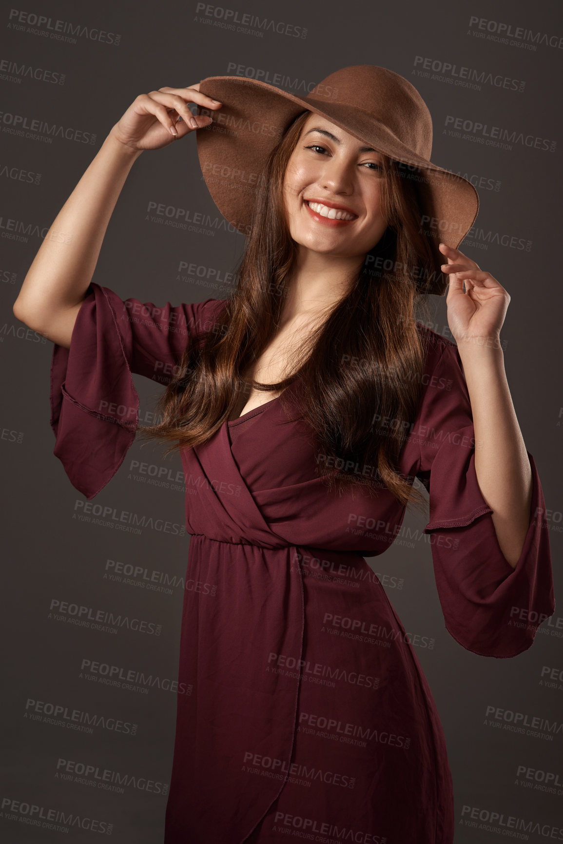 Buy stock photo Cropped portrait of an attractive young woman posing in studio against a grey background