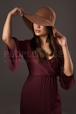 Buy stock photo Cropped shot of an attractive young woman posing in studio against a grey background