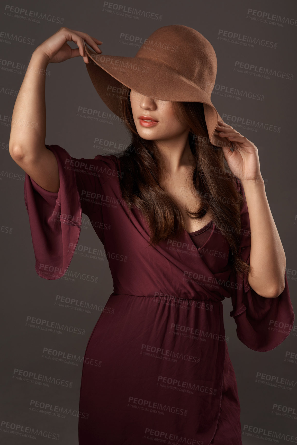 Buy stock photo Cropped shot of an attractive young woman posing in studio against a grey background