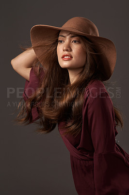 Buy stock photo Cropped shot of an attractive young woman posing in studio against a grey background