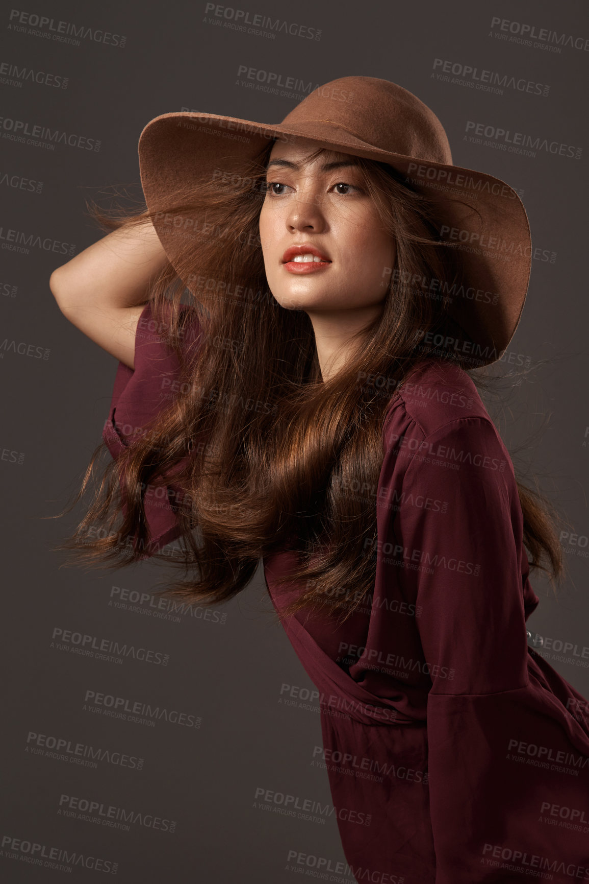 Buy stock photo Cropped shot of an attractive young woman posing in studio against a grey background