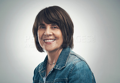 Buy stock photo Studio portrait of a senior woman standing against a grey background