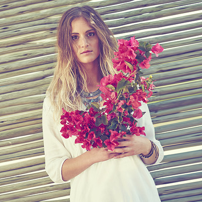 Buy stock photo Shot of an attractive young woman holding a bunch of fresh flowers