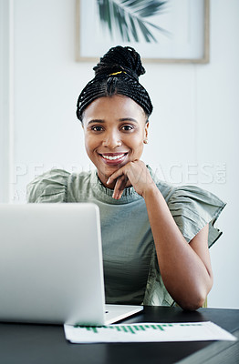 Buy stock photo Shot of an attractive young businesswoman sitting alone in her office and using her laptop