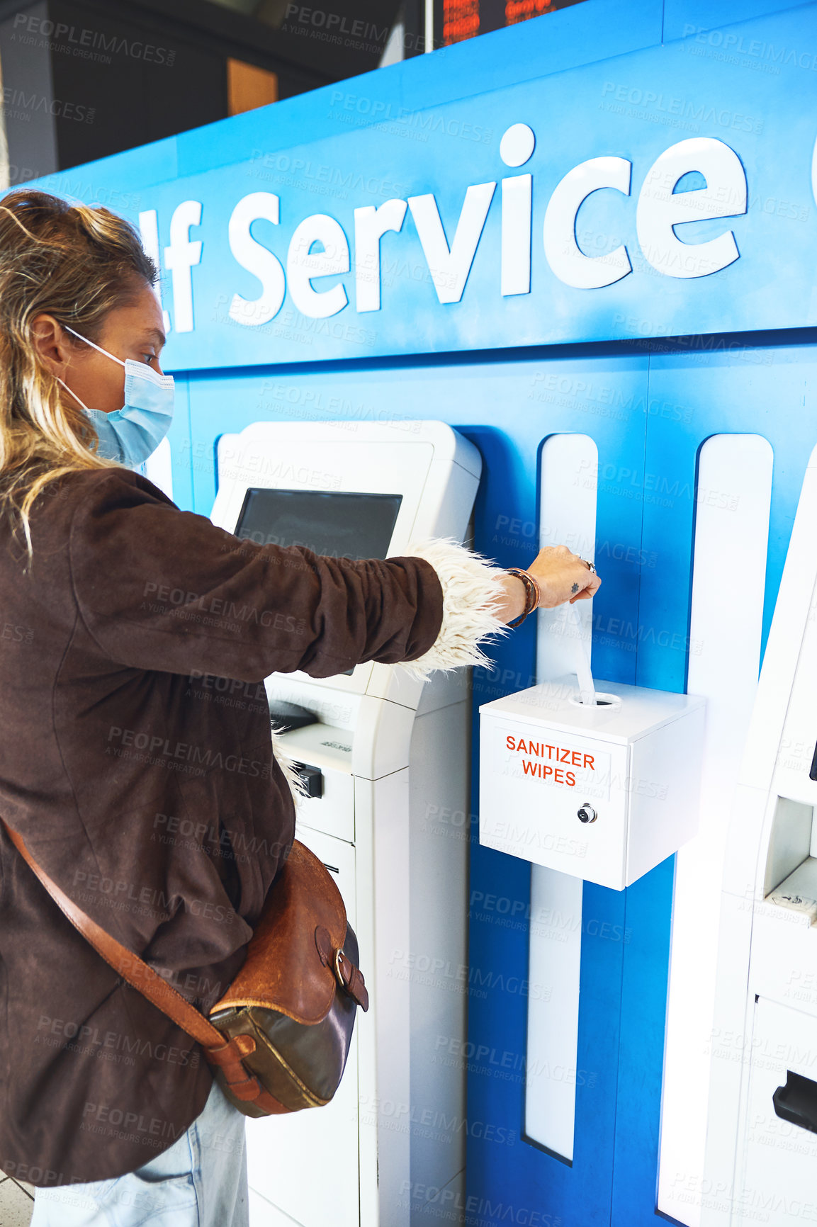 Buy stock photo Cropped shot of a person using the sanitiser wipes at the airport