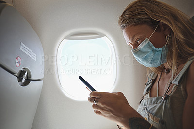 Buy stock photo Shot of a young woman using her phone in the aeroplane