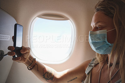 Buy stock photo Shot of  a young woman taking a selfie in the aeroplane