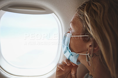 Buy stock photo Shot of a young woman looking out the window in the aeroplane