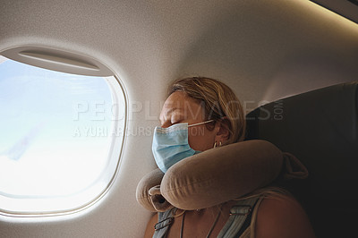 Buy stock photo Shot of a young woman sleeping in the aeroplane
