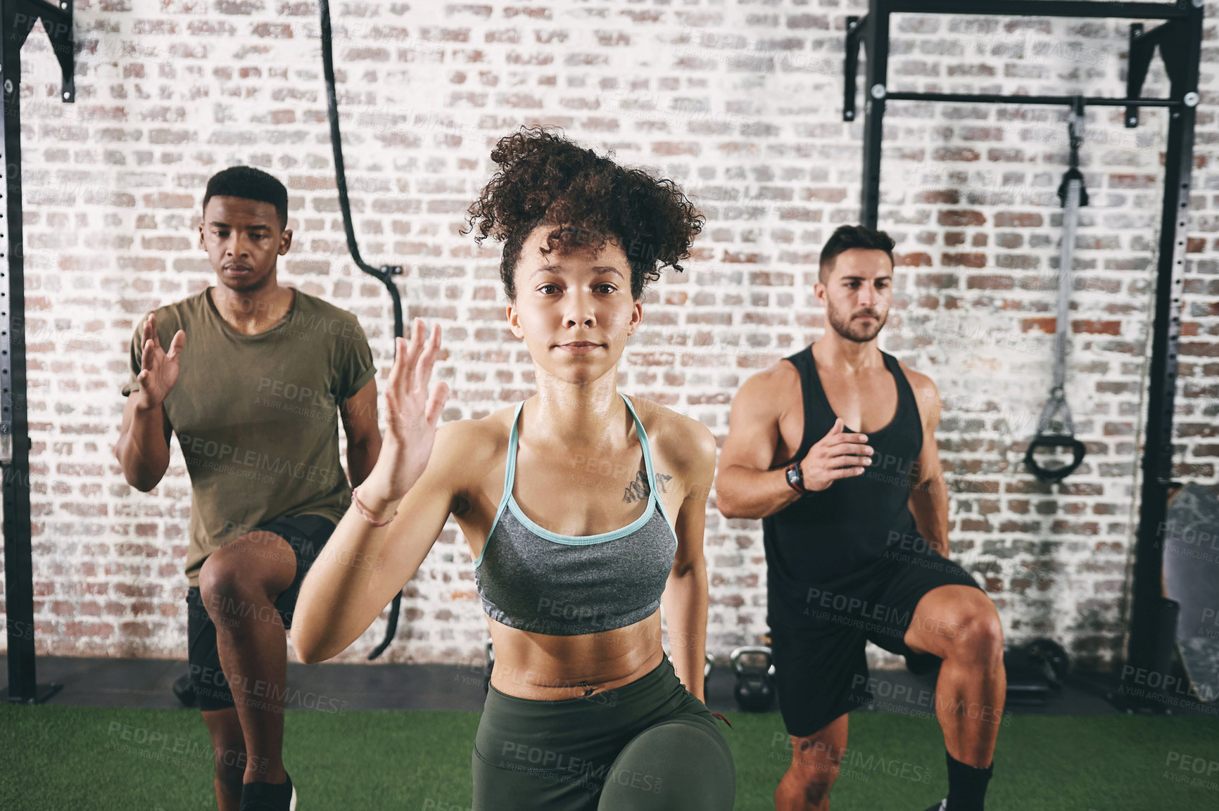 Buy stock photo Shot of a fitness group doing high knees while working out at the gym