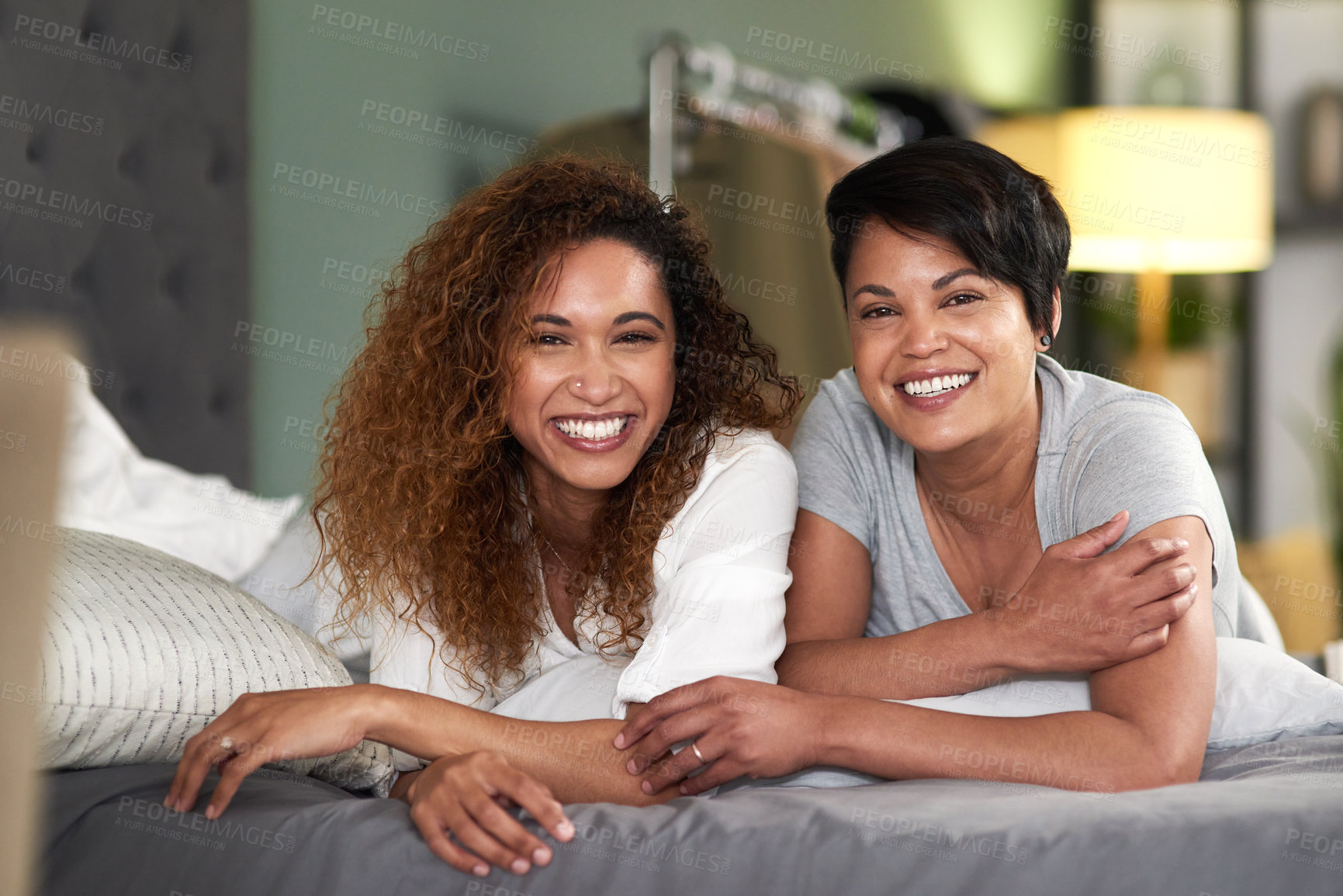 Buy stock photo Shot of an affectionate couple lying on their bed together