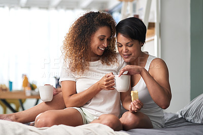 Buy stock photo Shot of a couple drinking coffee and eating rusks together at home