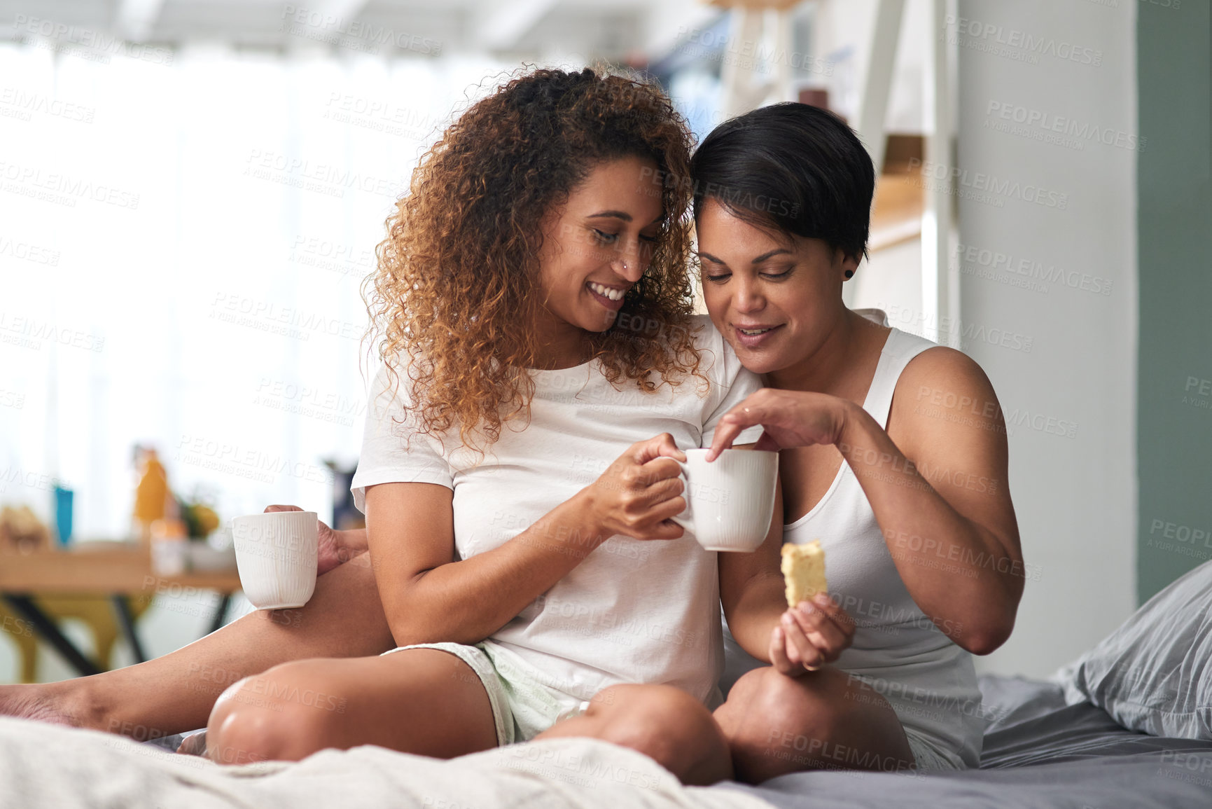 Buy stock photo Shot of a couple drinking coffee and eating rusks together at home