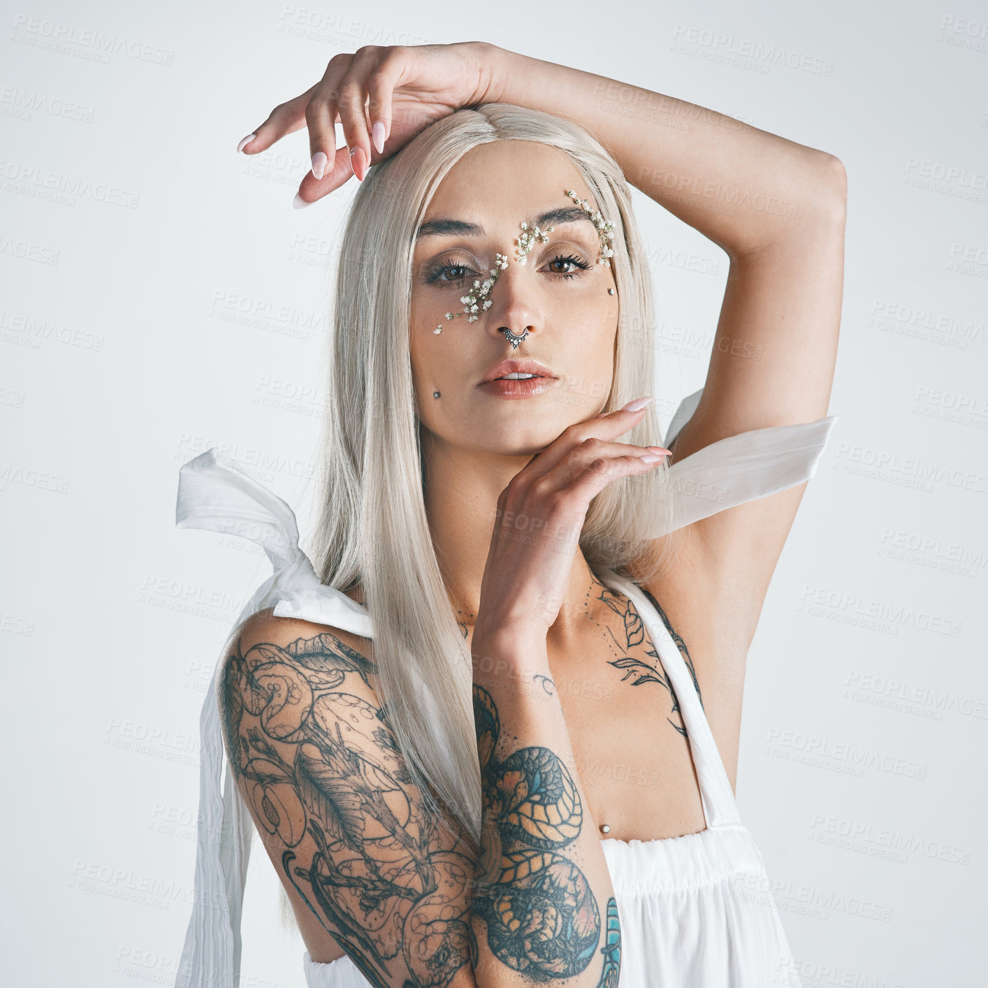 Buy stock photo Cropped portrait of an attractive young woman posing against a grey background in studio