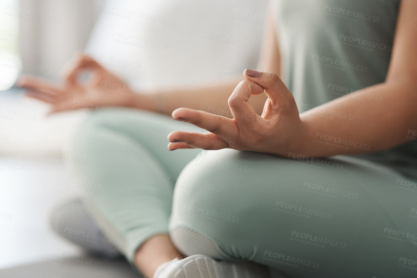 Buy stock photo Closeup shot of an unrecognisable woman meditating at home