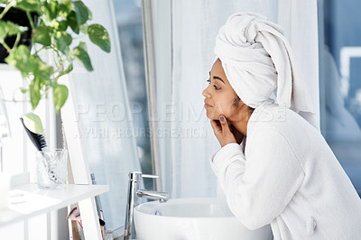 Buy stock photo Shot of a young woman going through her beauty routine at home