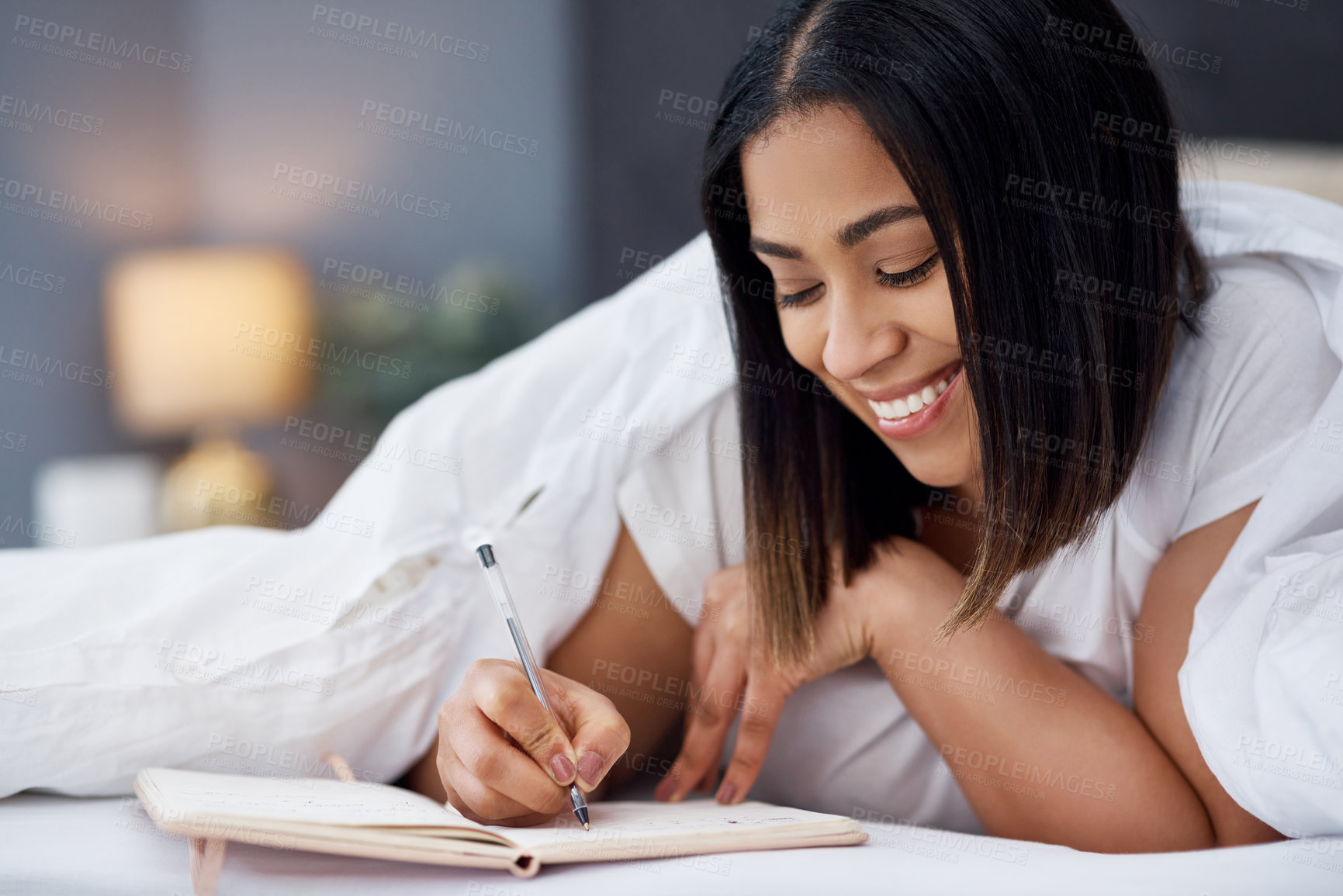 Buy stock photo Shot of a young woman in bed at home