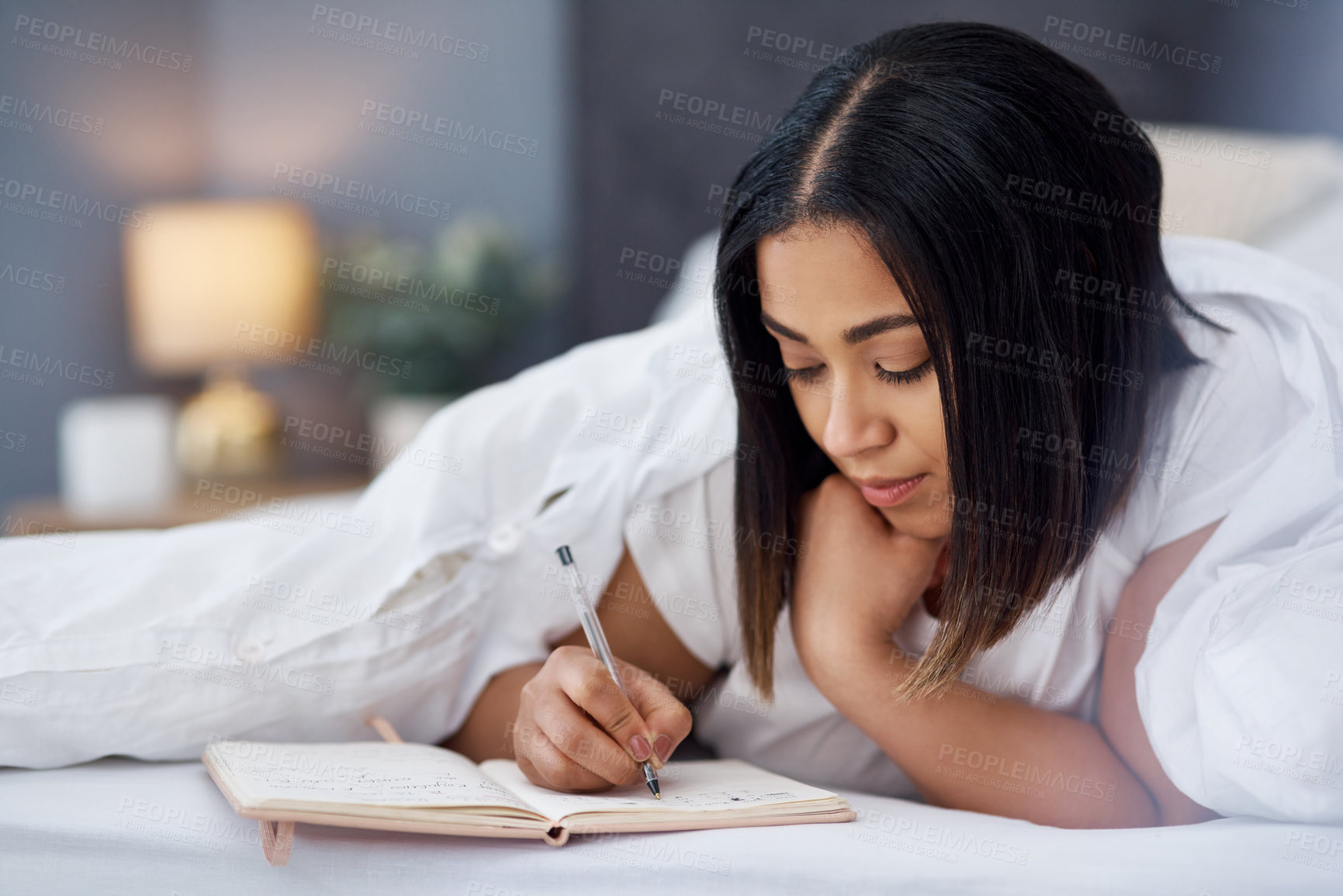 Buy stock photo Shot of a young woman in bed at home