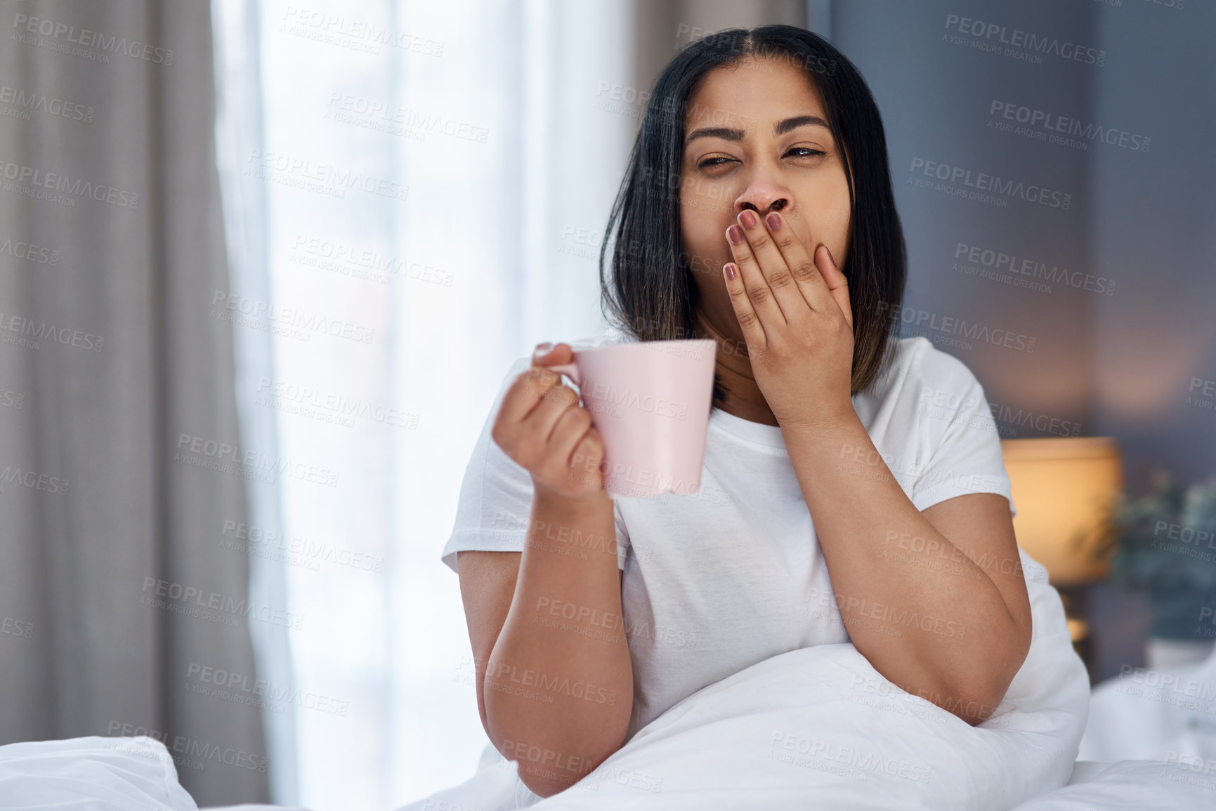 Buy stock photo Shot of a young woman in bed at home