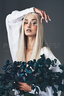 Buy stock photo Cropped portrait of an attractive young woman posing against a grey background in studio