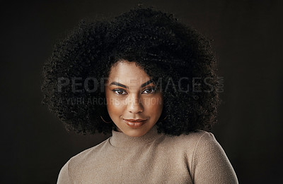 Buy stock photo Cropped portrait of an attractive young woman posing in studio against a dark background